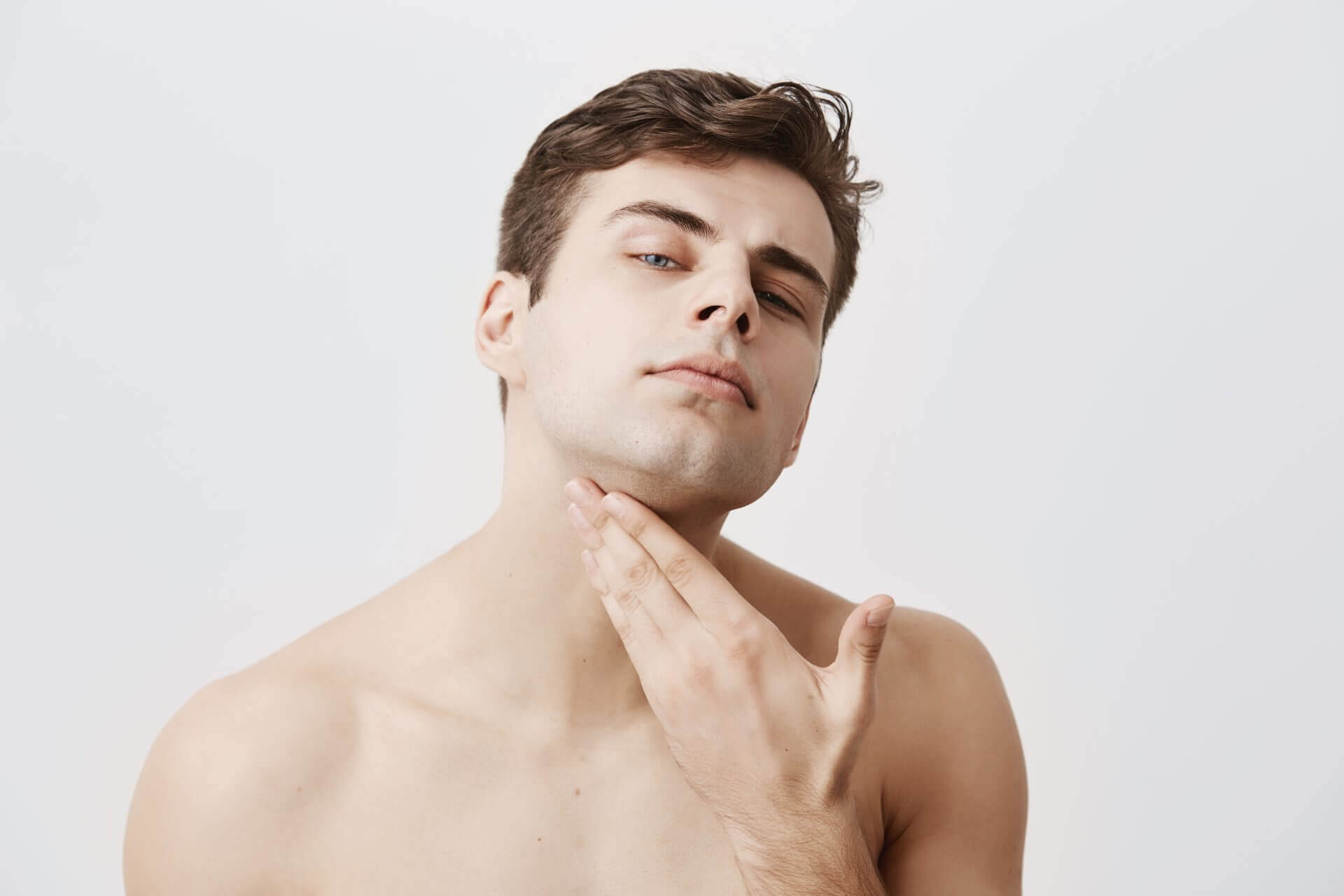 Confident man with pure healthy skin looking at camera