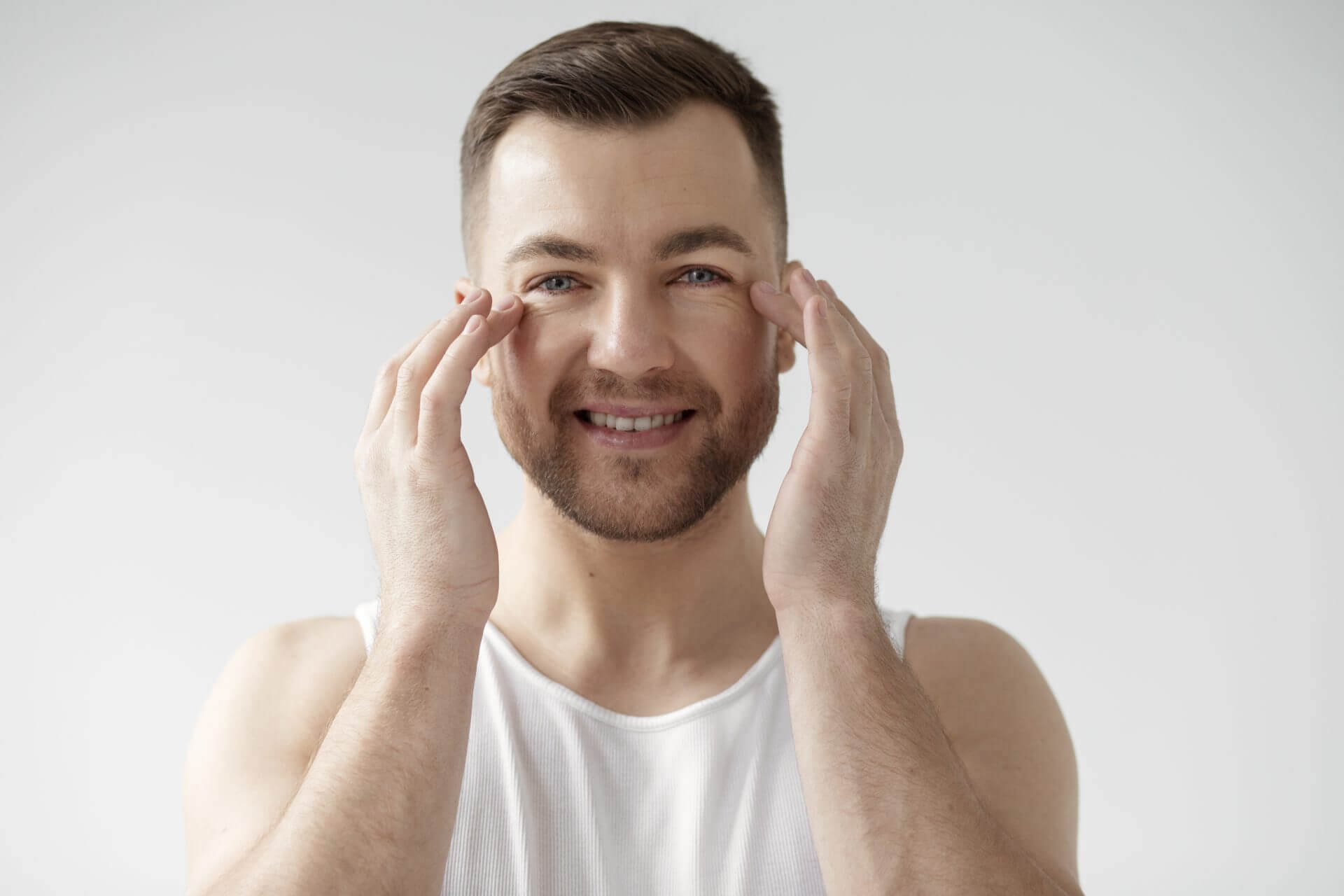 Young man applying his anti-aging treatment