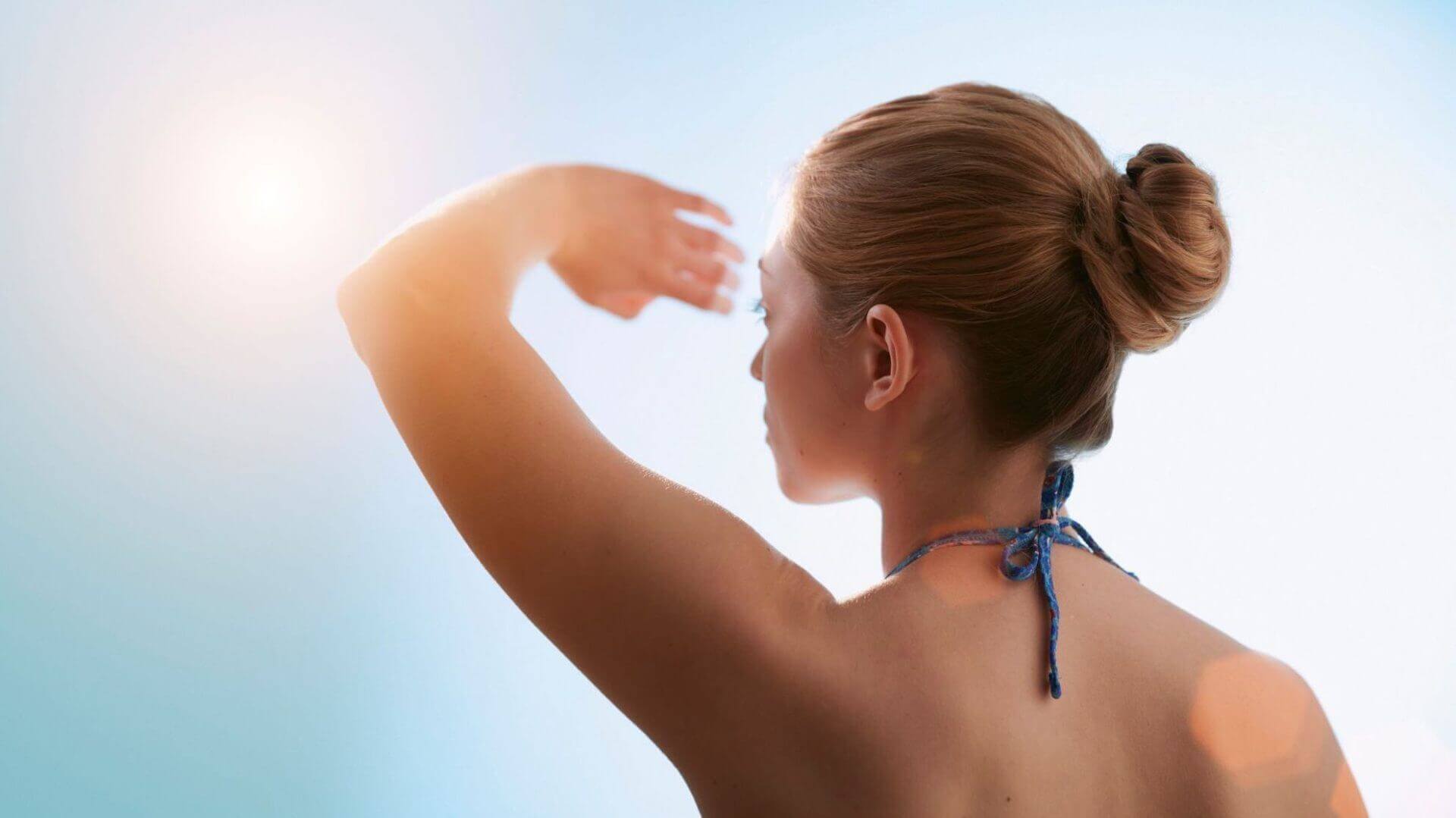 woman standing in direct sun