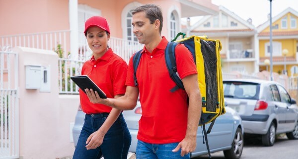 happy-couriers-delivering-order-working-express-service-wearing-red-cap-shirt-deliveryman-carrying-yellow-backpack-holding-tablet-delivery-service-online-shopping-concept
