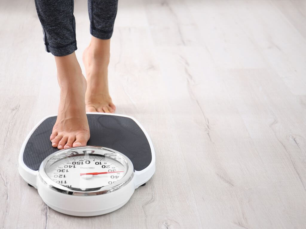 Women checking weight on scales